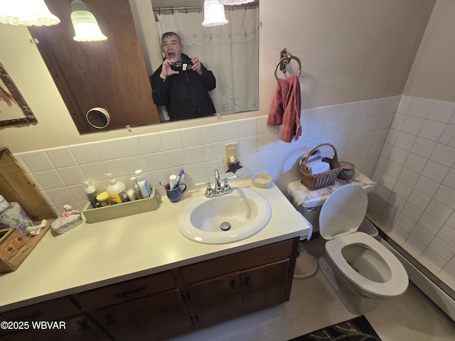 bathroom with tile walls, vanity, and toilet