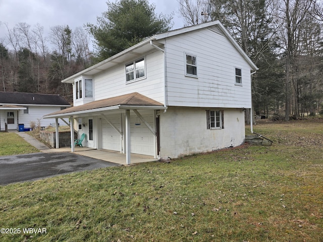 view of front of property with a front yard and a garage