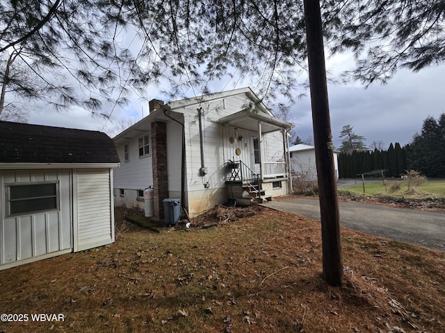 view of home's exterior with an outbuilding