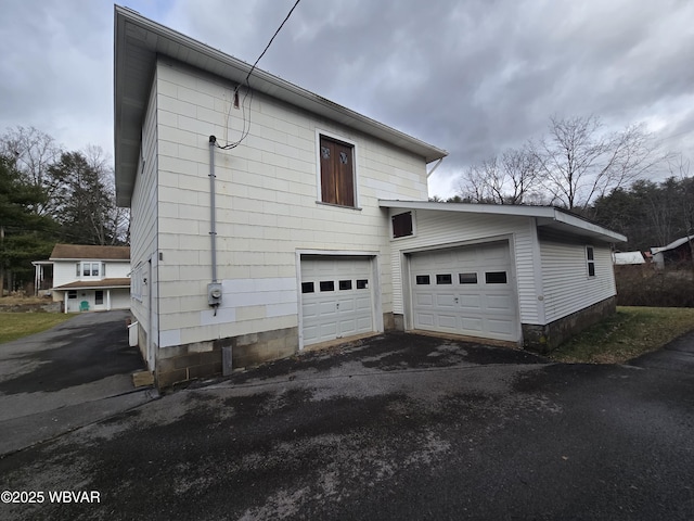 view of side of home featuring a garage