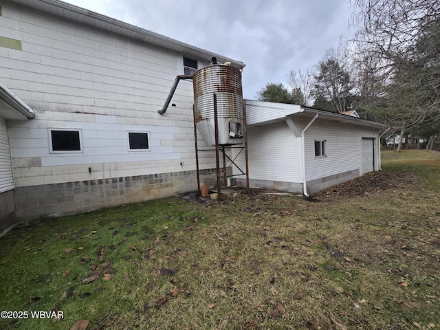 view of side of property with a lawn and a garage