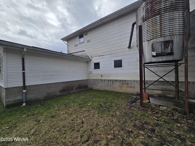 view of property exterior with a lawn