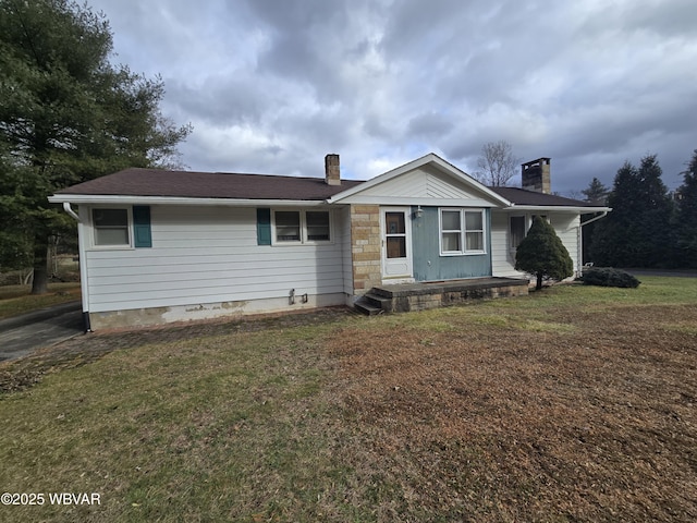 back of property featuring a yard and a chimney