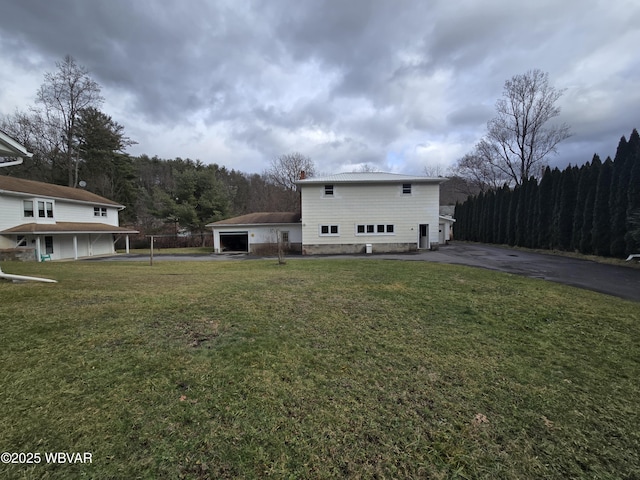 exterior space featuring a garage and a lawn