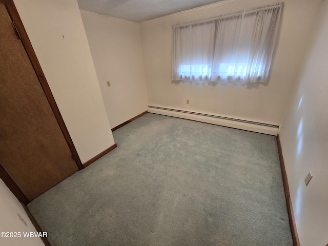 unfurnished room featuring a baseboard heating unit, baseboards, and light colored carpet