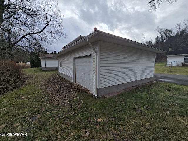 garage featuring a lawn