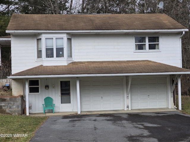 view of front of home featuring covered porch and a garage