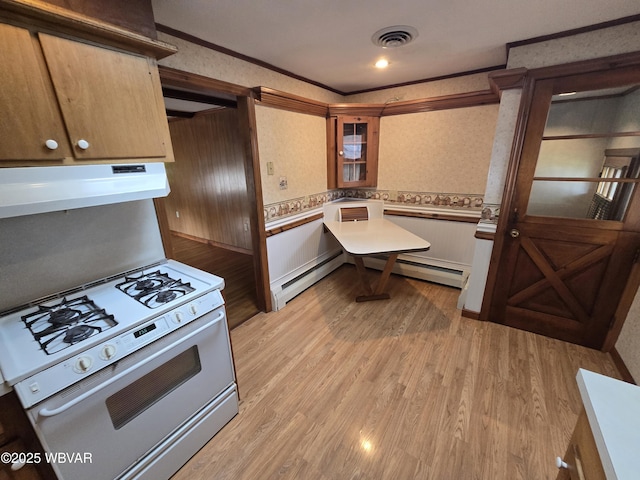 kitchen featuring light countertops, white gas range, wallpapered walls, and under cabinet range hood