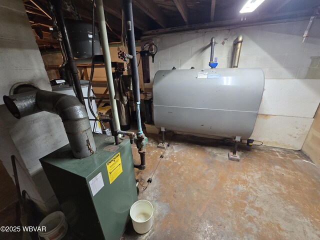 utility room featuring a heating unit and heating fuel