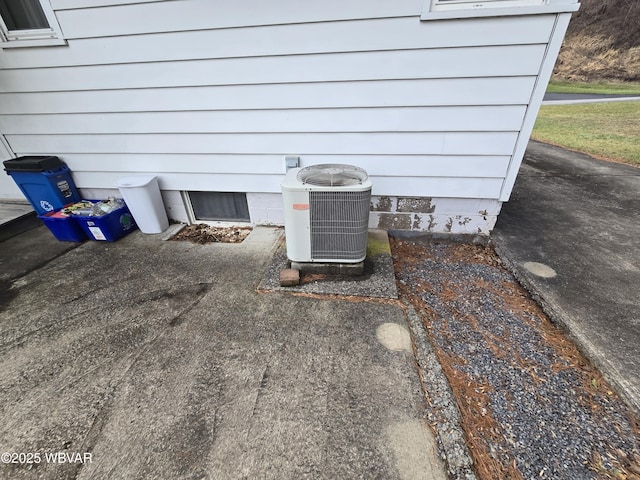 exterior details featuring a wood stove and central AC unit