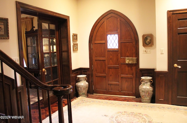 entrance foyer featuring wooden walls