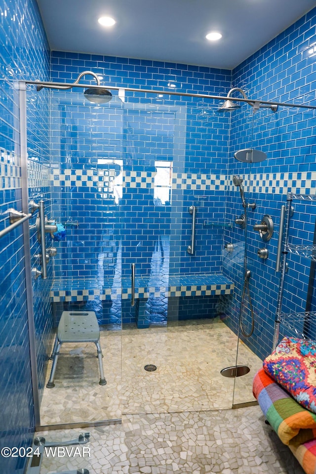 bathroom featuring a shower with door