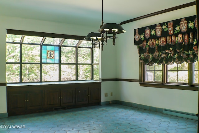 unfurnished dining area with an inviting chandelier, plenty of natural light, and baseboard heating