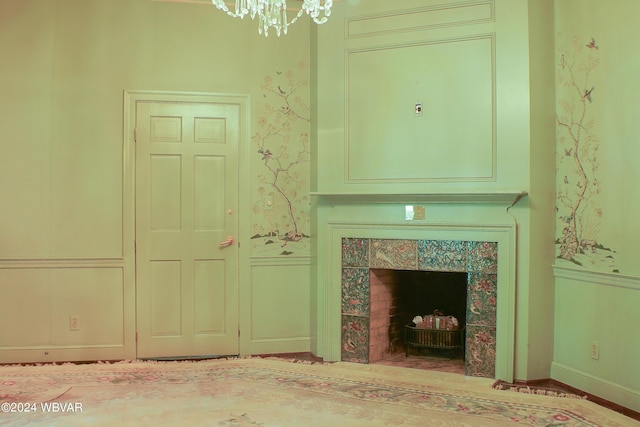 unfurnished living room featuring a notable chandelier and a fireplace