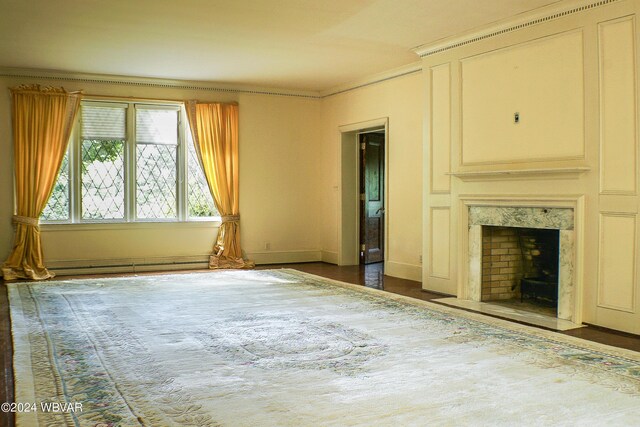 unfurnished living room with a high end fireplace, a baseboard radiator, dark hardwood / wood-style floors, and ornamental molding