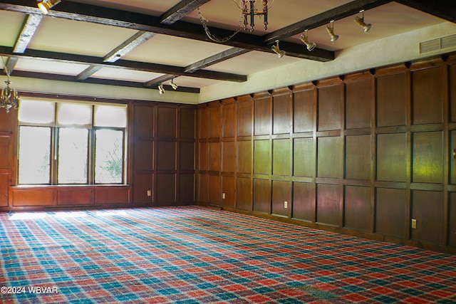 interior space with dark colored carpet and rail lighting