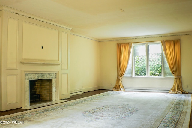 unfurnished living room featuring a premium fireplace, a baseboard radiator, and hardwood / wood-style flooring