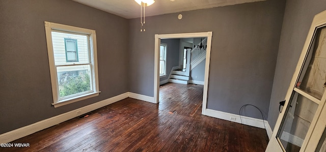 empty room featuring ceiling fan and dark hardwood / wood-style flooring