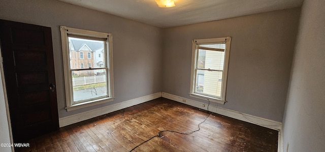 empty room featuring dark hardwood / wood-style floors and a wealth of natural light