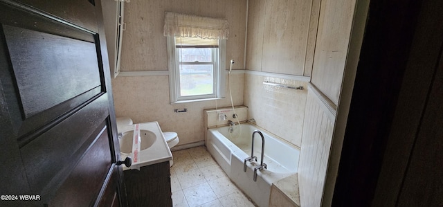 bathroom with vanity, toilet, and a bath