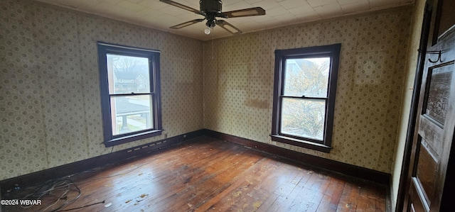 empty room featuring wood-type flooring and ceiling fan