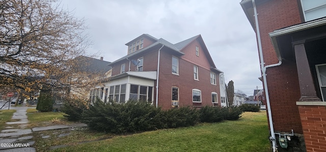 view of home's exterior with a yard