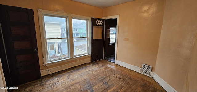 unfurnished room with hardwood / wood-style flooring