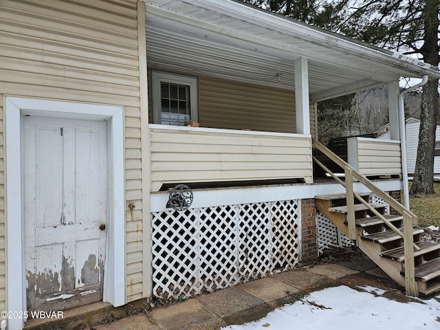 view of snow covered property entrance