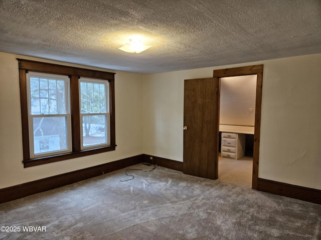 unfurnished bedroom featuring carpet and a textured ceiling