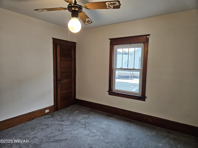 spare room with carpet and ceiling fan