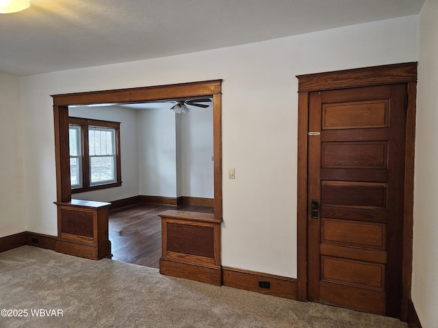 empty room with dark carpet and ceiling fan