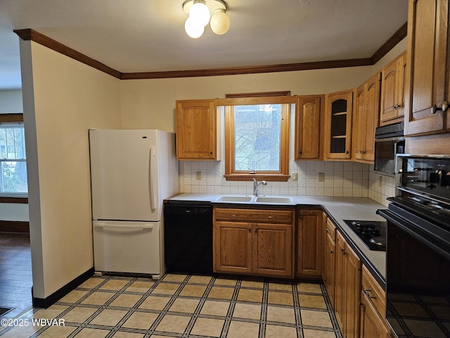 kitchen featuring black appliances, backsplash, crown molding, and sink