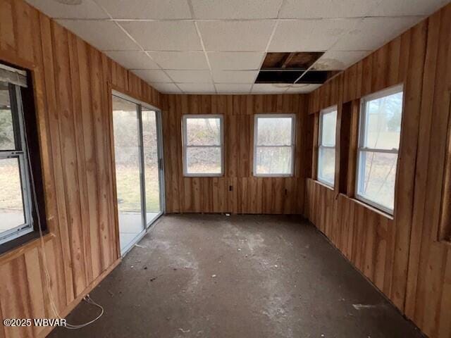 unfurnished sunroom with a drop ceiling