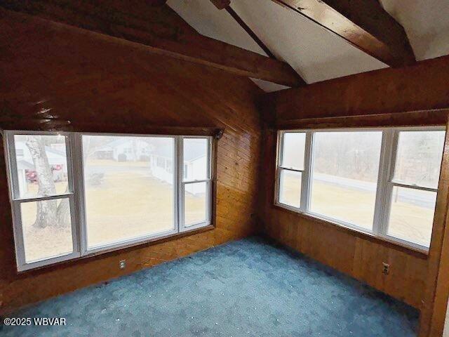 unfurnished sunroom with lofted ceiling with beams