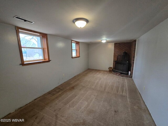 1833 Poco Ln, Williamsport, PA 17701 - basement featuring carpet floors, visible vents, and a wood stove