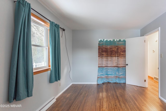 1833 Poco Ln, Williamsport, PA 17701 - unfurnished room with wood finished floors, baseboards, a baseboard heating unit, and visible vents