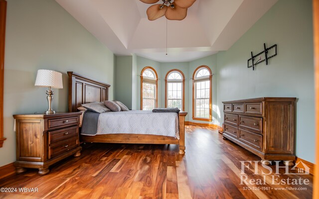 bedroom featuring ceiling fan, dark wood-type flooring, and vaulted ceiling