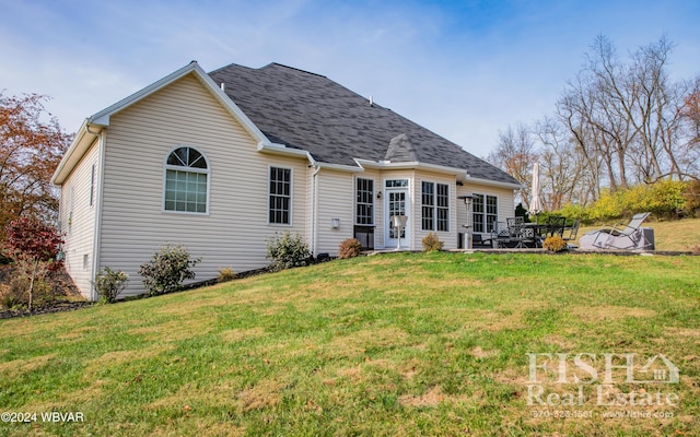 rear view of house featuring a yard