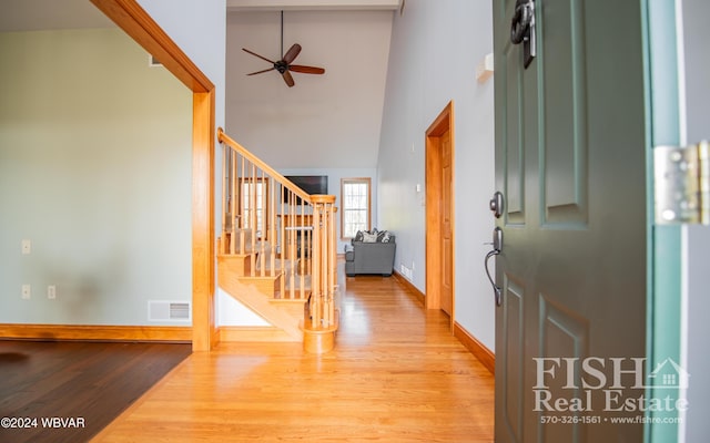 entrance foyer featuring ceiling fan, high vaulted ceiling, and light wood-type flooring