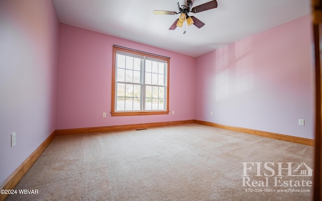 spare room featuring ceiling fan and carpet floors