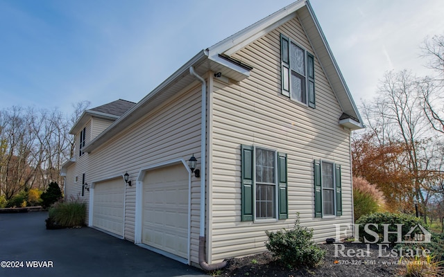 view of side of home featuring a garage