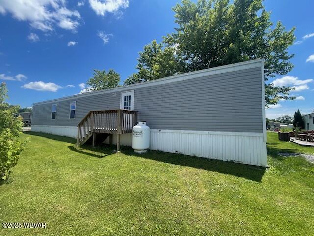 14 Albatross Dr, Watsontown, PA 17777 - back of property with a deck, a yard, and stairway
