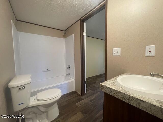 14 Albatross Dr, Watsontown, PA 17777 - bathroom featuring a textured ceiling, wood finished floors, vanity, and  shower combination