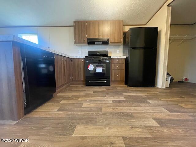 14 Albatross Dr, Watsontown, PA 17777 - kitchen with black appliances, under cabinet range hood, light wood-type flooring, and light countertops