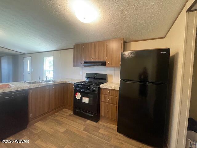 14 Albatross Dr, Watsontown, PA 17777 - kitchen with black appliances, under cabinet range hood, a textured ceiling, light wood finished floors, and brown cabinetry