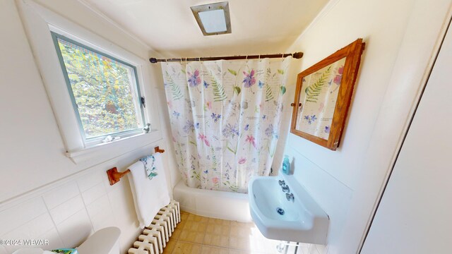 bathroom featuring shower / bath combo, sink, radiator heating unit, and ornamental molding