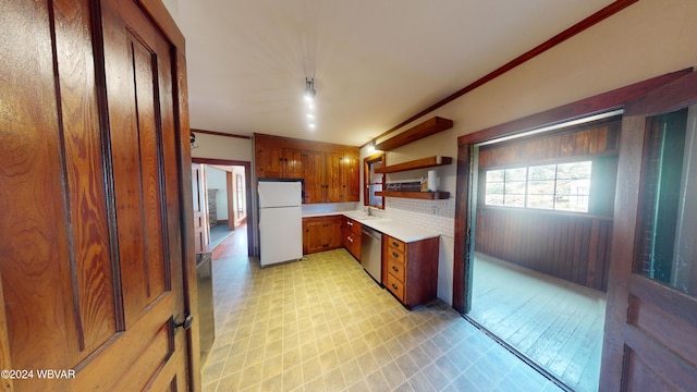 kitchen featuring decorative backsplash, ornamental molding, sink, dishwasher, and white fridge