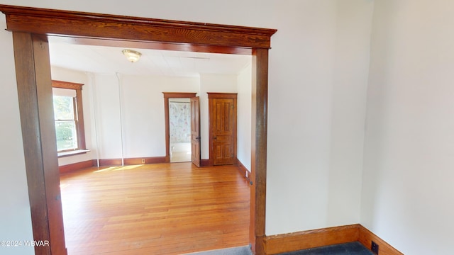 unfurnished room with light wood-type flooring