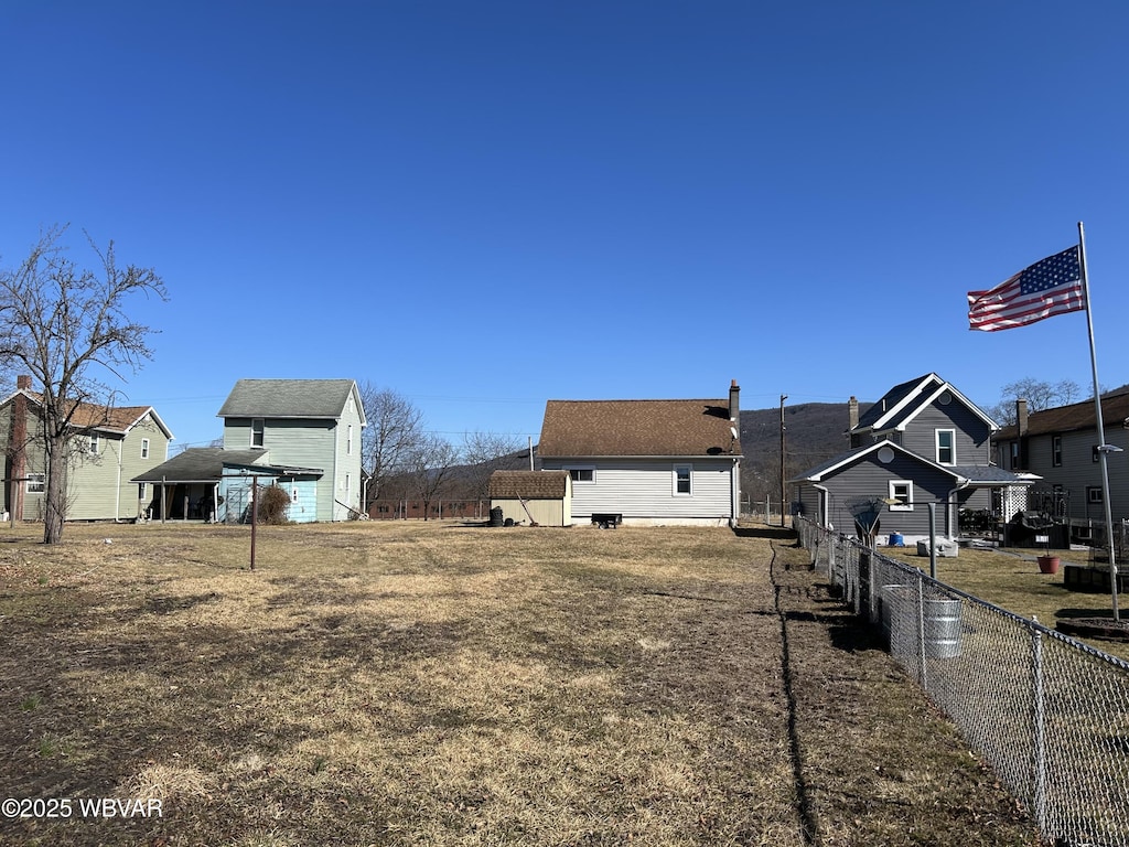 view of yard featuring a residential view and fence