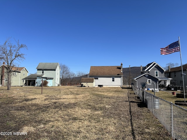 view of yard featuring a residential view and fence